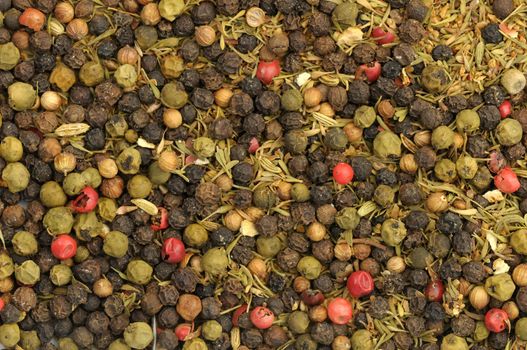 Green, black and pink whole peppercorns assortment with herbs and different seeds