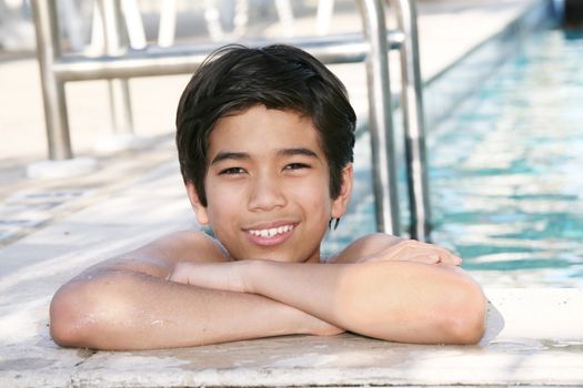 Young boy relaxing  in the pool