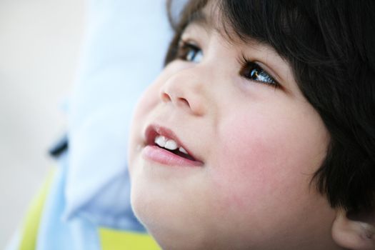 Handsome toddler boy profile,smiing and looking up