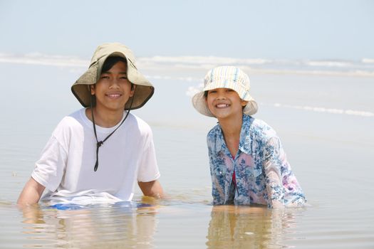 Two children enjoying the water at ocean shore