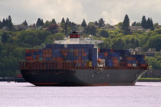 Container Ship with smoke or steam coming out of the top of the stack. Logos have been obscurred or otherwise removed.
