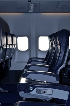 Row of empty seats in commercial aircraft cabin