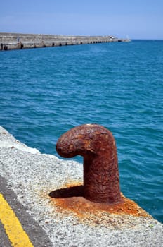 Old rusty cleat in the Mediterranean port of Heraklion, Crete, Greece