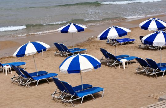summer: sunbeds and umbrellas in mediterranean beach