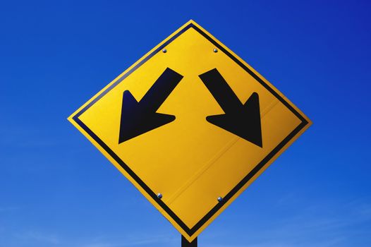 A street signpost against sunny blue sky.             