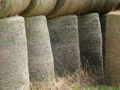 Round bales of hay stacked on top of each other.