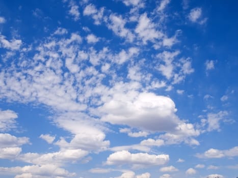 Summer clouds on a bright blue afternoon sky.