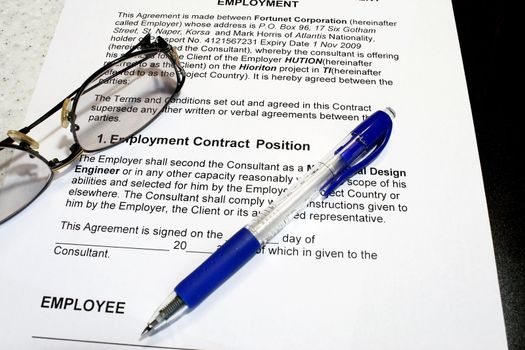 Employment Contract with pen and eyeglass- note that data are fiction.