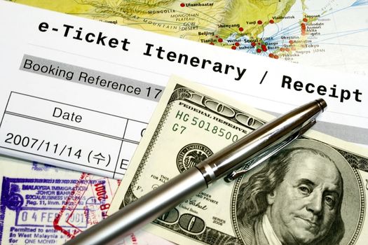 Travel Documents e-ticket itenerary passport and dollar - concept for travel.