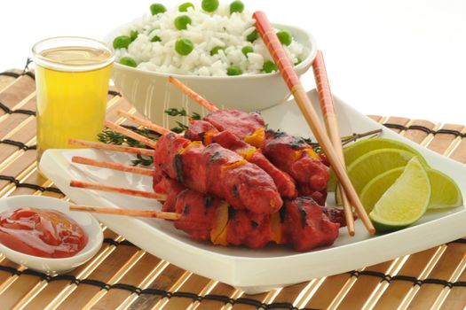 Spicy chicken satay served with white rice.