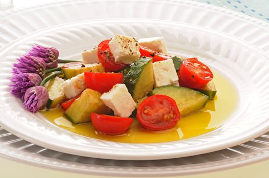 Delicious greek salad on a white plate.