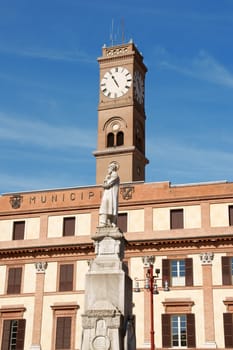 Detail of the Town Hall in Forlì (Forum Livii), the civic tower in the background and the statue of Aurelio Saffi in the foreground. This palace once called Palazzo Ordelaffi, from the name of the family who ruled the town in the thirteenth century, rises on the trapezoidal square called Piazza Aurelio Saffi.