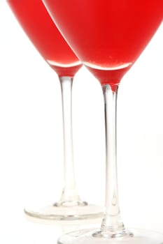 Close-up of two cocktail glasses with red liquid inside