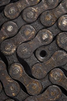 Macro image of a dirty oily bicycle chain as a background.
