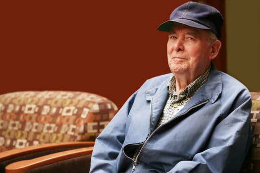 Senior man sitting in waiting room of hospital