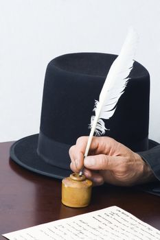 A photograph of the Gettysburg address being penned with a quill.