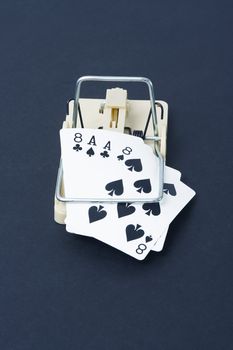 Dead man's hand is caught in a rat trap to depict gambling addiction.