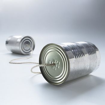 two tin cans connected by a piece of string