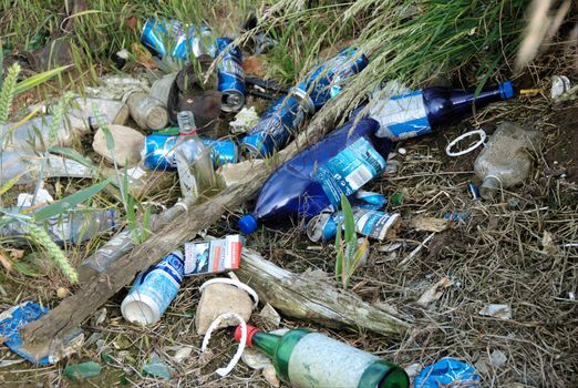 Fly Tipping ?.Empty bottles,cans and rubbish litter the countryside .