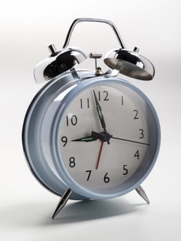 an old fashioned alarm clock with chrome bells shot on a white background