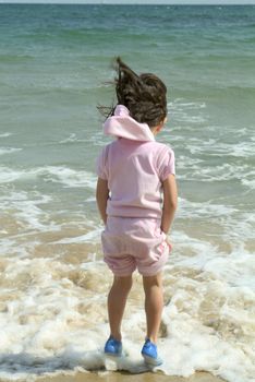 child playing by waters edge