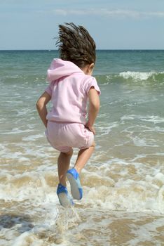 child playing by waters edge