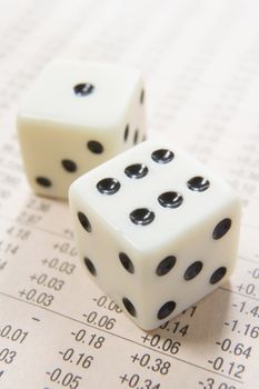 pair of dice on a paper with columns of numbers