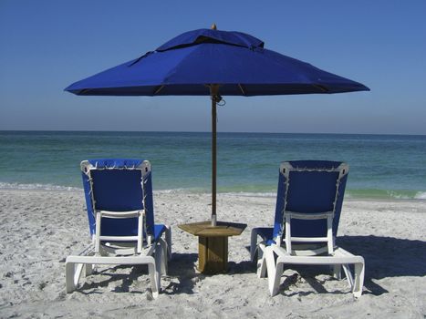 2 sun loungers on a beach