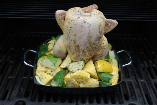 beer butt chicken on the grill with veggies is a great way to cook chicken