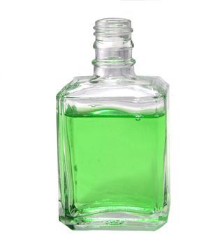 A clear glass bottle holds refreshing green tonic, isolated on a white background.