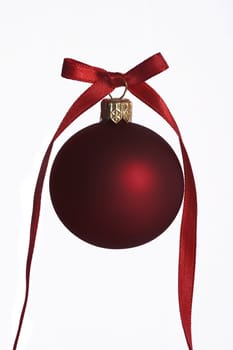christmas ball with decorative red ribbon on white background
