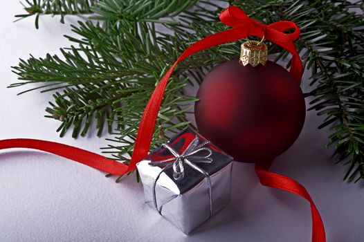 christmas decoration with red ball, gift; ribbon and tree on white background