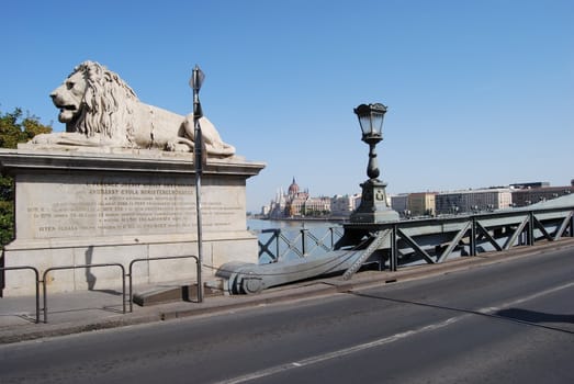 Lion monument marks entrance to bridge crossing the Danube in Hungary.