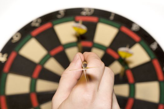 Darts hitting the bullseye on a dartboard