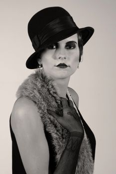 Retro styled fashion portrait of a young woman. Clothing and make-up in twenties style.