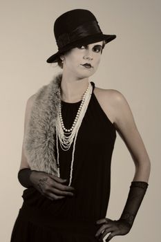 Retro styled fashion portrait of a young woman. Clothing and make-up in twenties style.