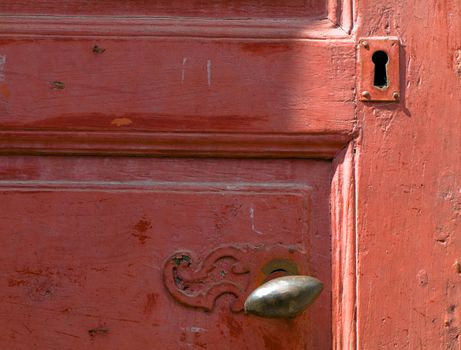 Vintage red door with handle and keyhole