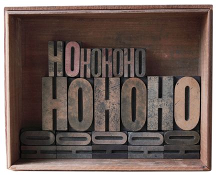 a wooden box filled with 'ho ho ho' in different sizes of wood type
