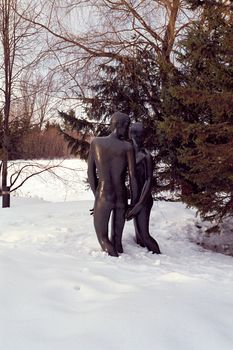 Statue of couple walking in the snow
