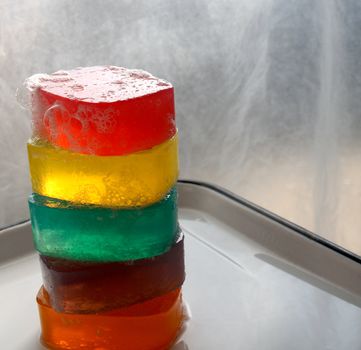 multicolored glycerin soaps on a white tray