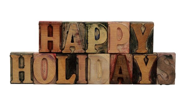 the words 'happy holidays' in old wood type letters 