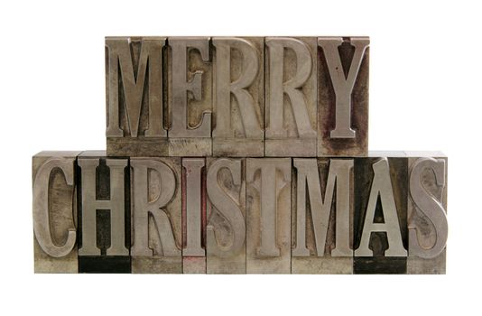 the phrase 'merry christmas' in letterpress metal letters isolated on white