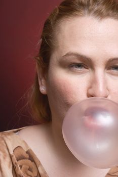 Women blowing a big bubble gum