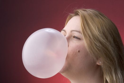 Profile of a women blowing a bubble