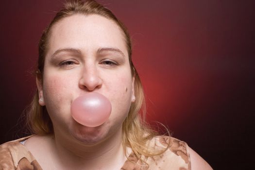 Women blowing small bubble gum