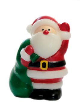 a Santa Claus figure with bright eyes and a green bag full of goodies