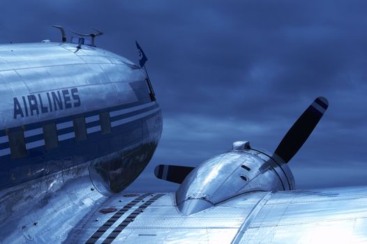 Old airplane (dc-3) with blue toning against the sky.