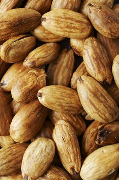 Roasted and sea salted almond nuts texture background