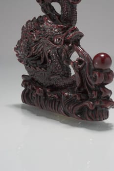 Chinese dragon statue floating over a white surface
