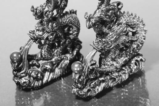 Close up of two dragon racing in black and white